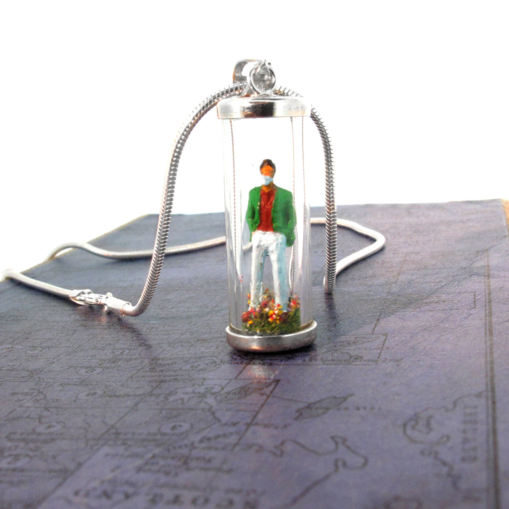 i-So. Miniature hand painted man, stood on wild meadow.