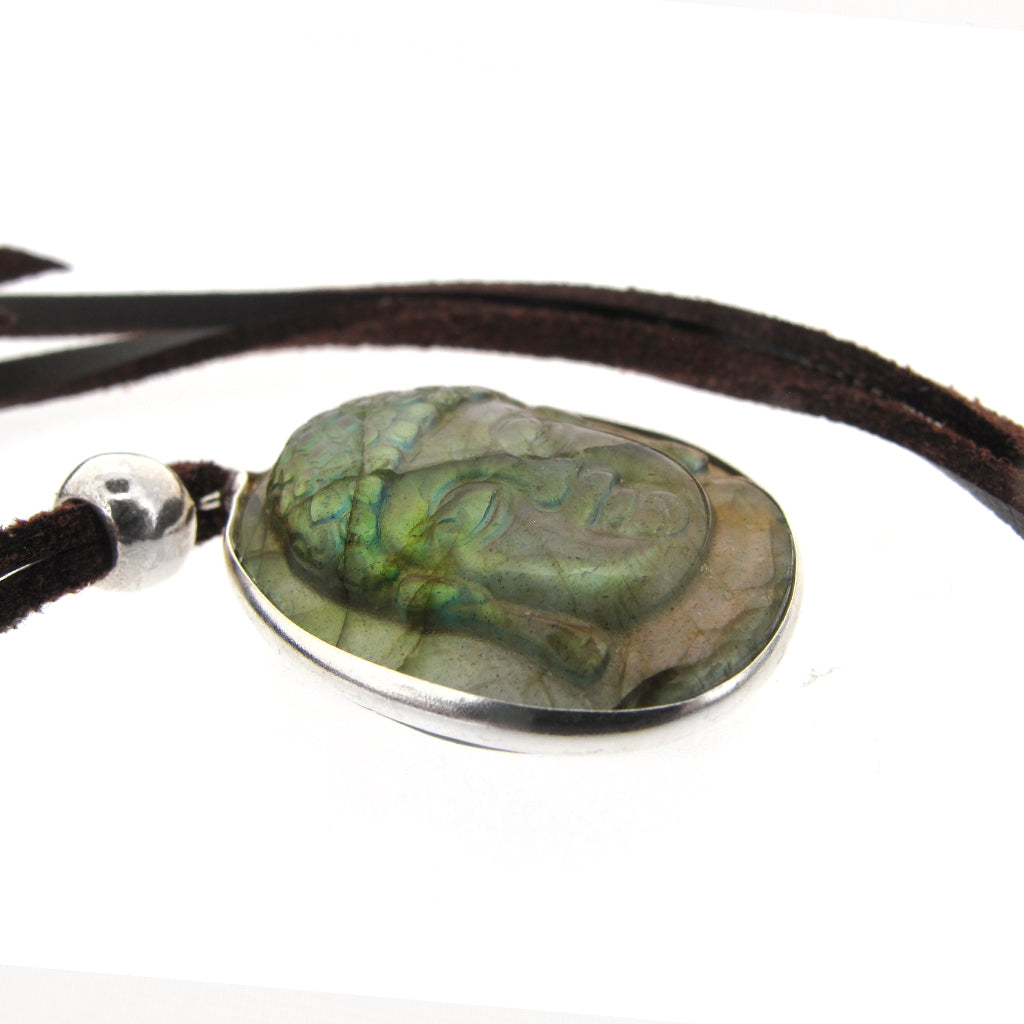 Buddha head pendant carved in Labradorite with sterling silver mount, on brown faux suede cord