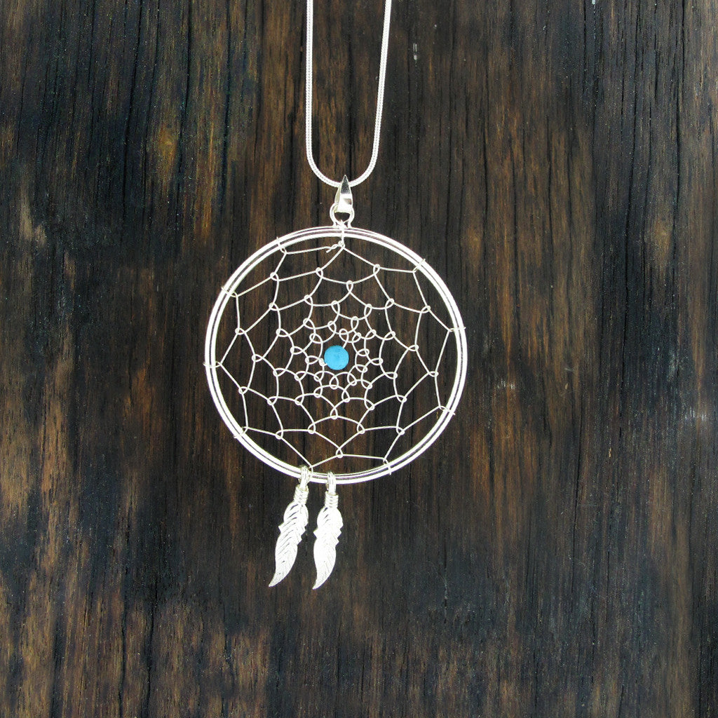 Dream catcher sterling silver pendant with urquoise stone on sterling silver snake chain.