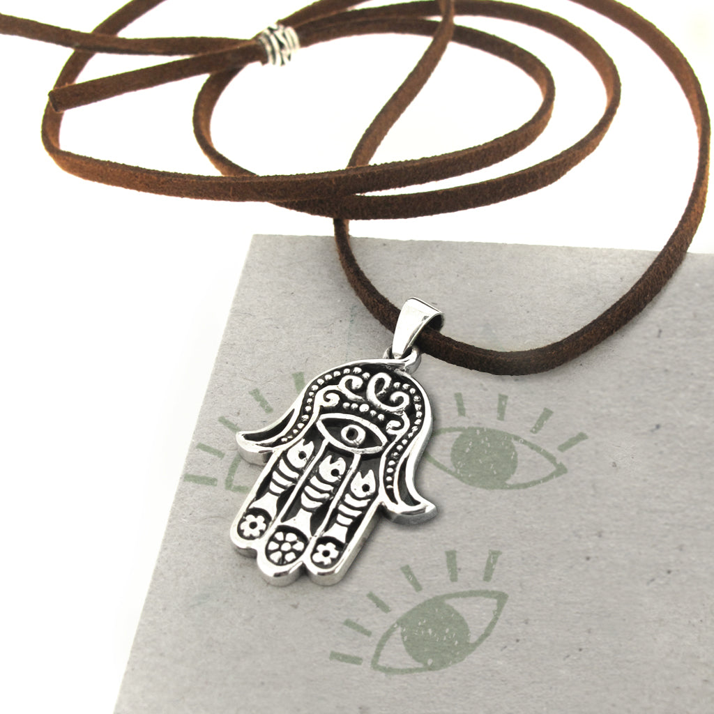Hand of fatama sterling silver pendant, on brown faux suede