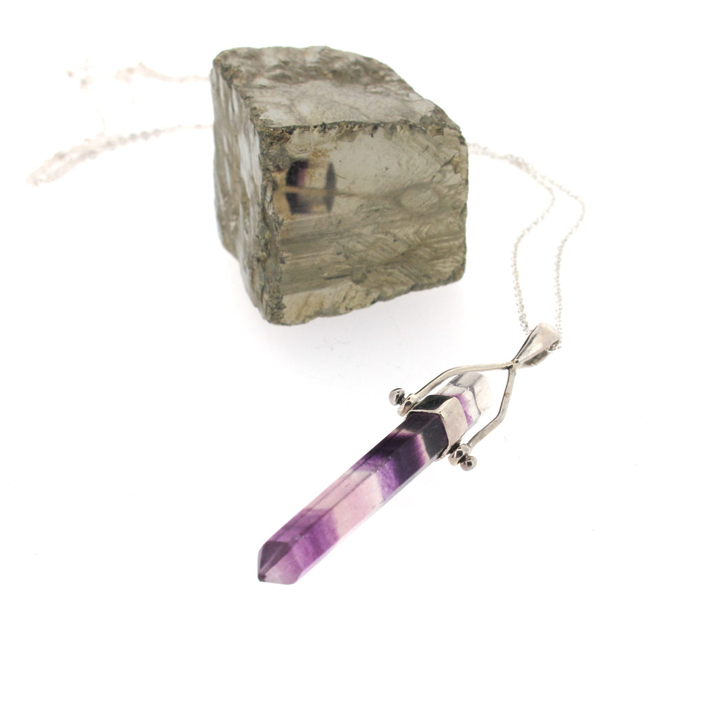 Fluorite crystal point pendant, sterling silver casing and sterling silver chain.