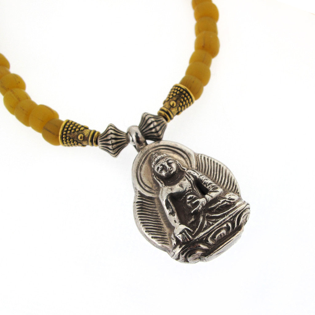 Tibetan seated silver Buddha on glass bead necklace