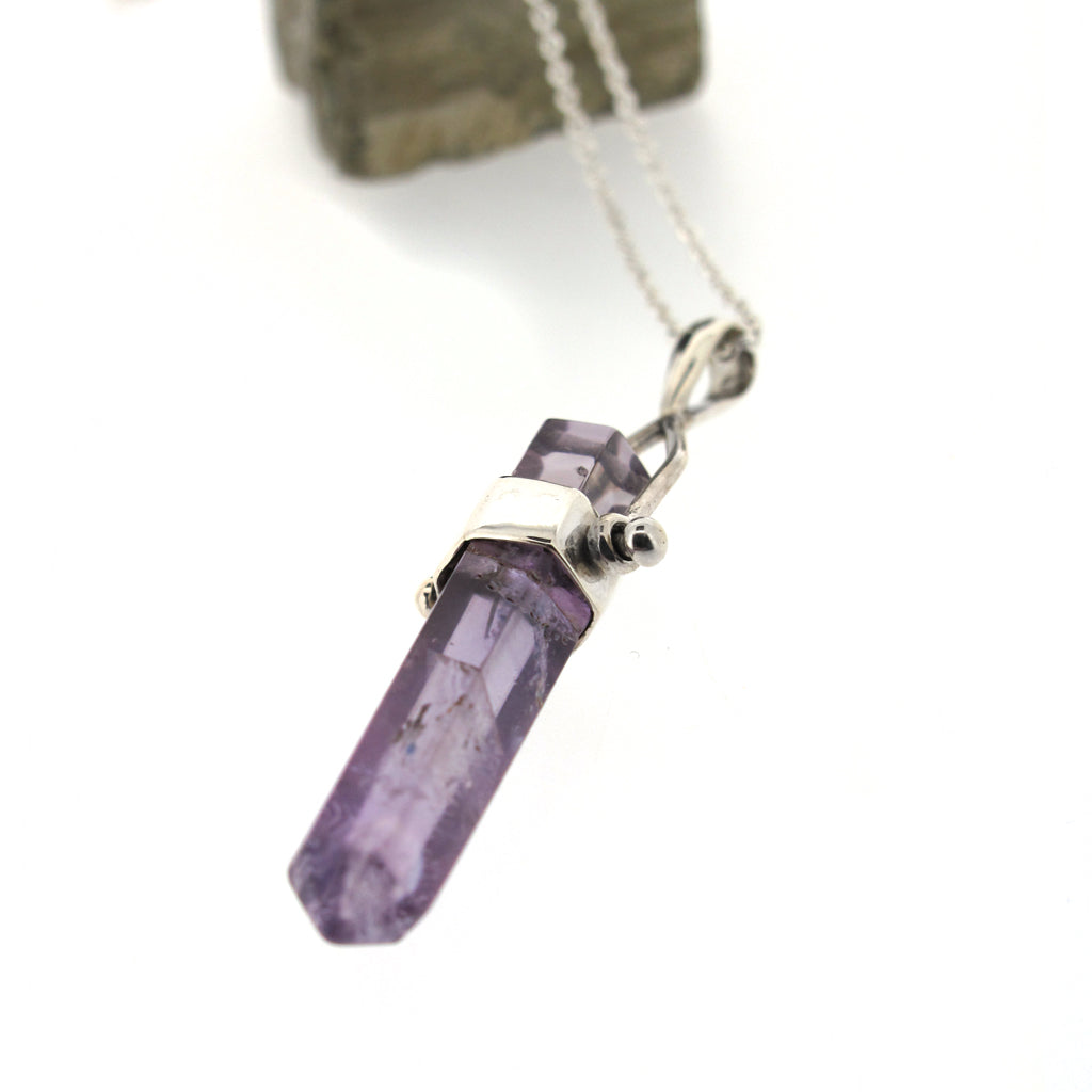 Amethyst crystal point pendant, sterling silver casing and sterling silver chain.