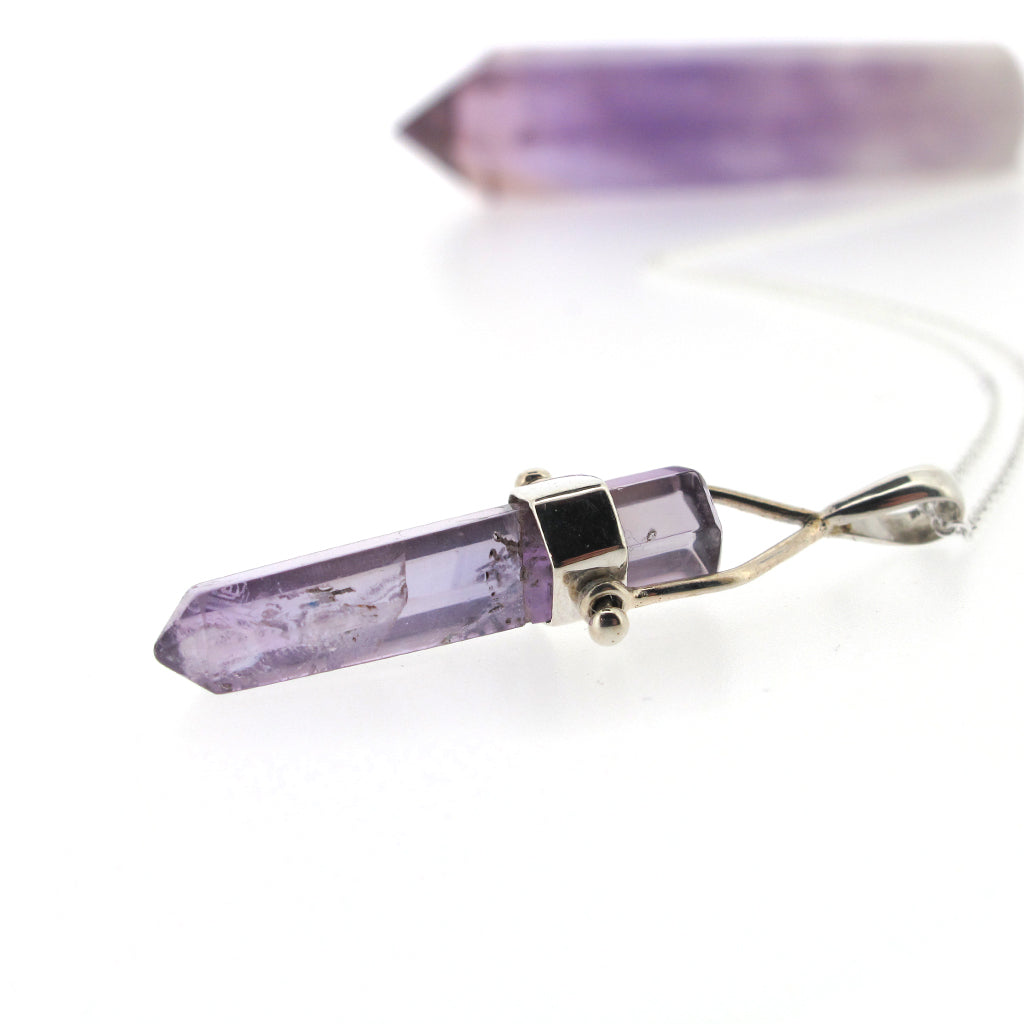 Amethyst crystal point pendant, sterling silver casing and sterling silver chain.