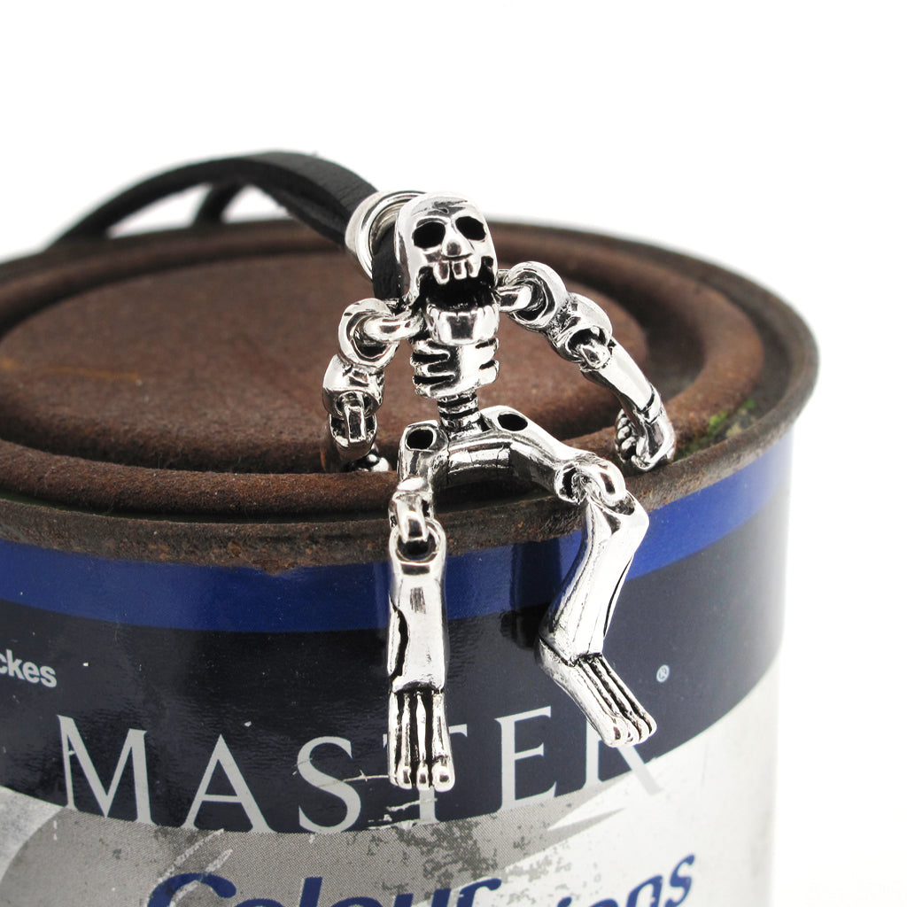 Skeleton with moving limbs sterling silver pendant on black faux suede cord