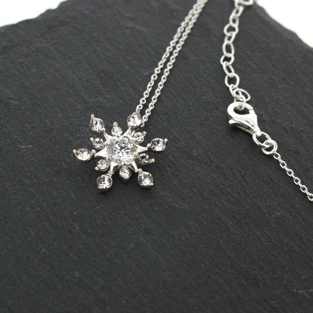 cubic zirconia crystal snow flake pendant on an adjustable sterling silver chain.