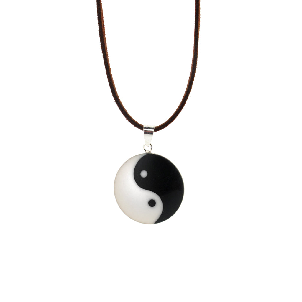 Ying and Yang sterling silver pendant, on faux brown suede