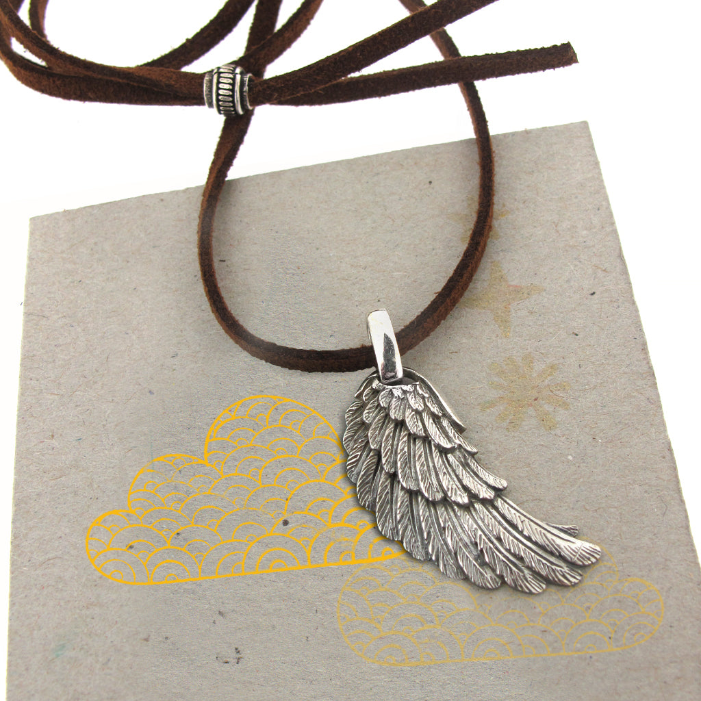 Angel wing, sterling silver pendant on brown faux suede